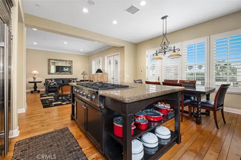 a kitchen with granite countertop a stove and a dining table