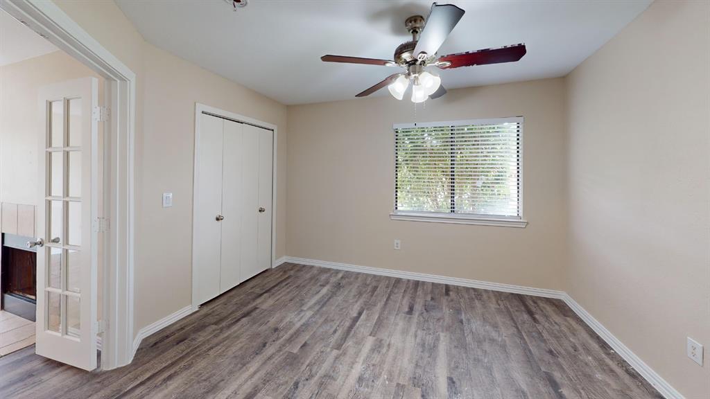 9837 Walnut Street, Unit 103 Dallas, TX 75243 - Photo 9 of 10 Unfurnished bedroom featuring wood finished floors, a closet, and a ceiling fan