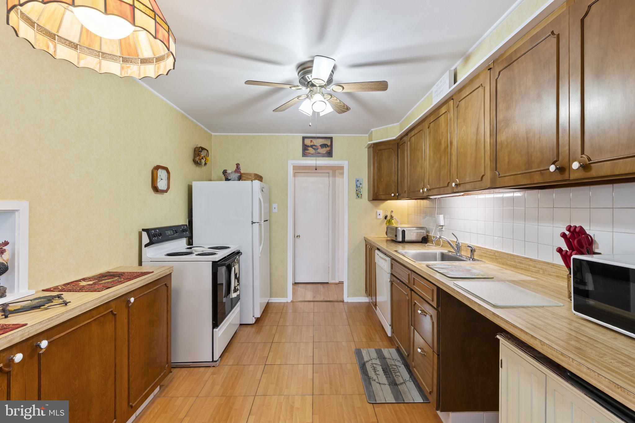 2940 Stoney Creek Road Norristown, PA 19401 - Photo 13 of 43 a kitchen with granite countertop stainless steel appliances sink stove top oven and cabinets