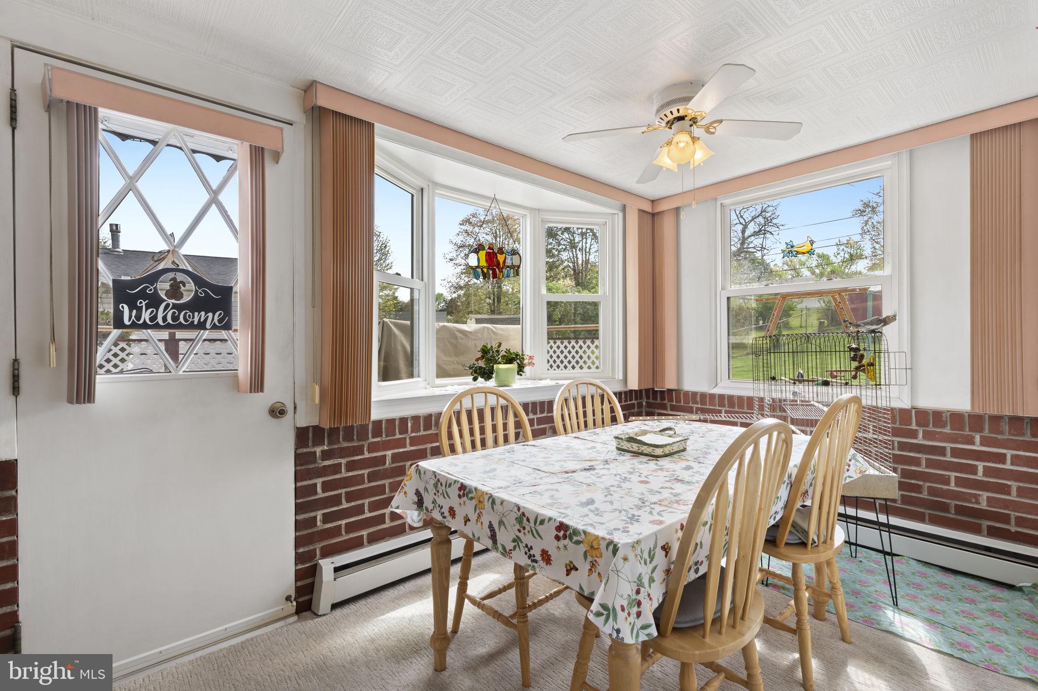 2940 Stoney Creek Road Norristown, PA 19401 - Photo 16 of 43 a view of a dining room with furniture large windows and wooden floor