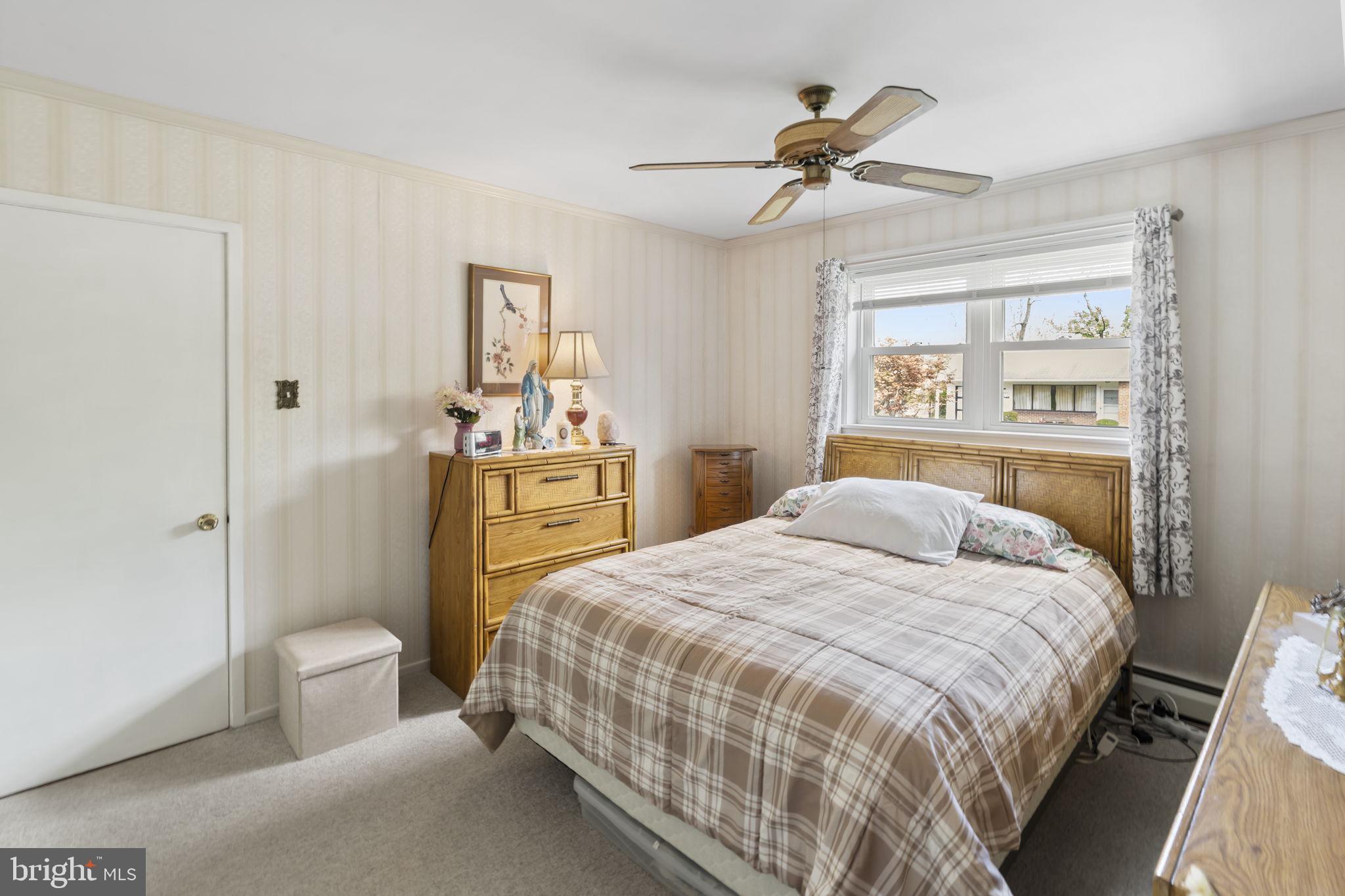 2940 Stoney Creek Road Norristown, PA 19401 - Photo 22 of 43 a bedroom with a bed and a chandelier