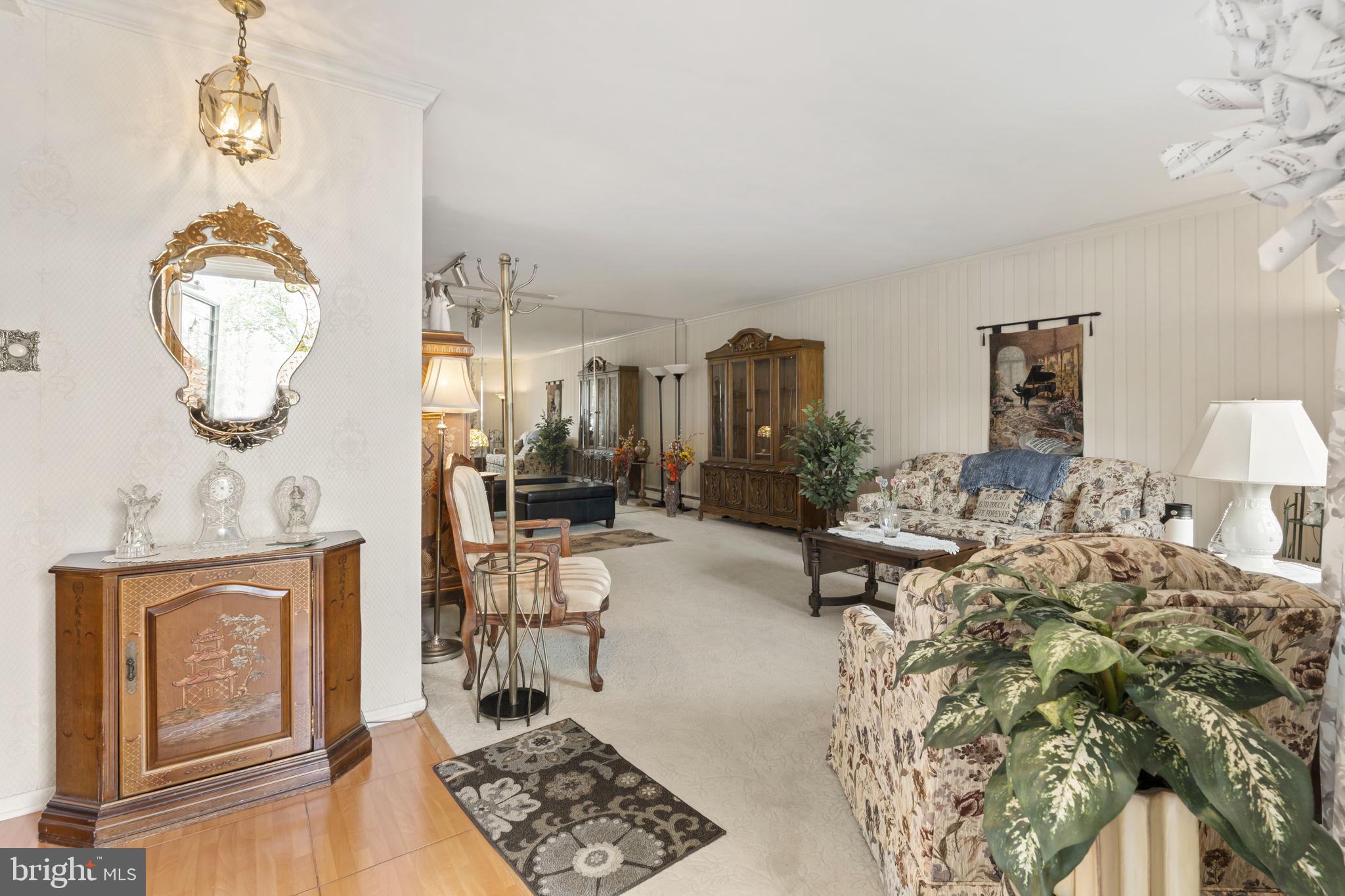 2940 Stoney Creek Road Norristown, PA 19401 - Photo 5 of 43 a living room with furniture a rug and white walls