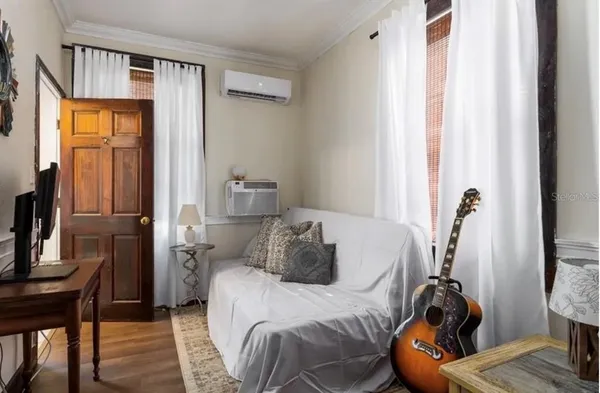 a bedroom with a bed and wooden floor