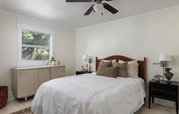 a bedroom with a bed and a window