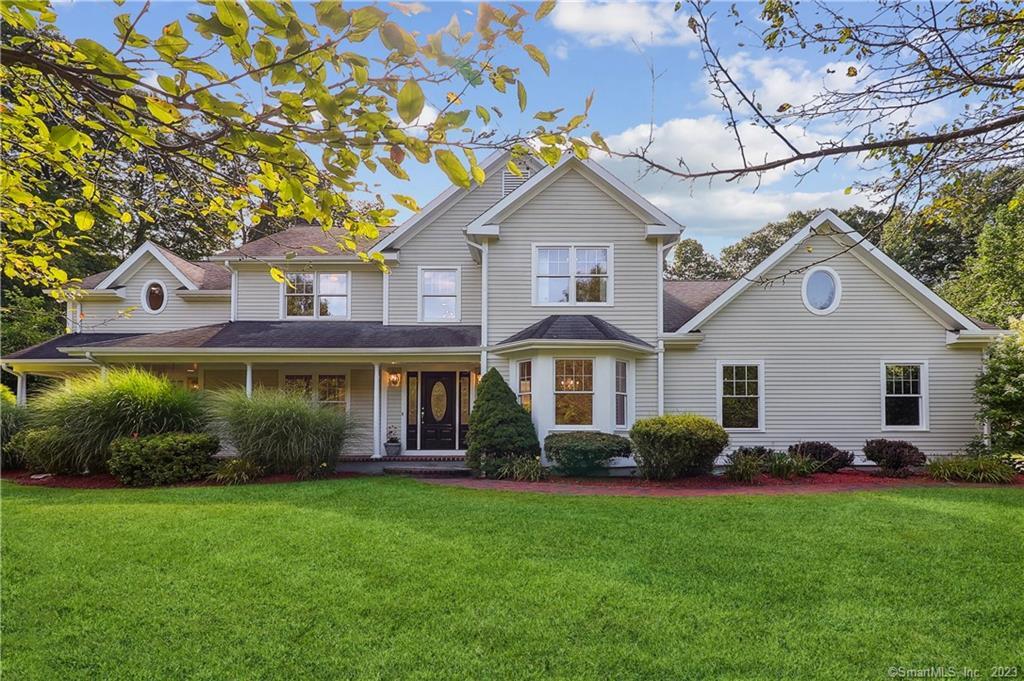 a front view of house with yard and green space