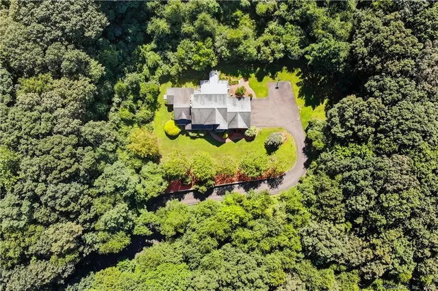 an aerial view of a house with a yard