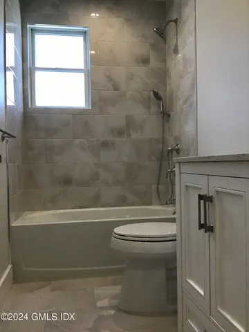 a bathroom with a toilet and a bathtub