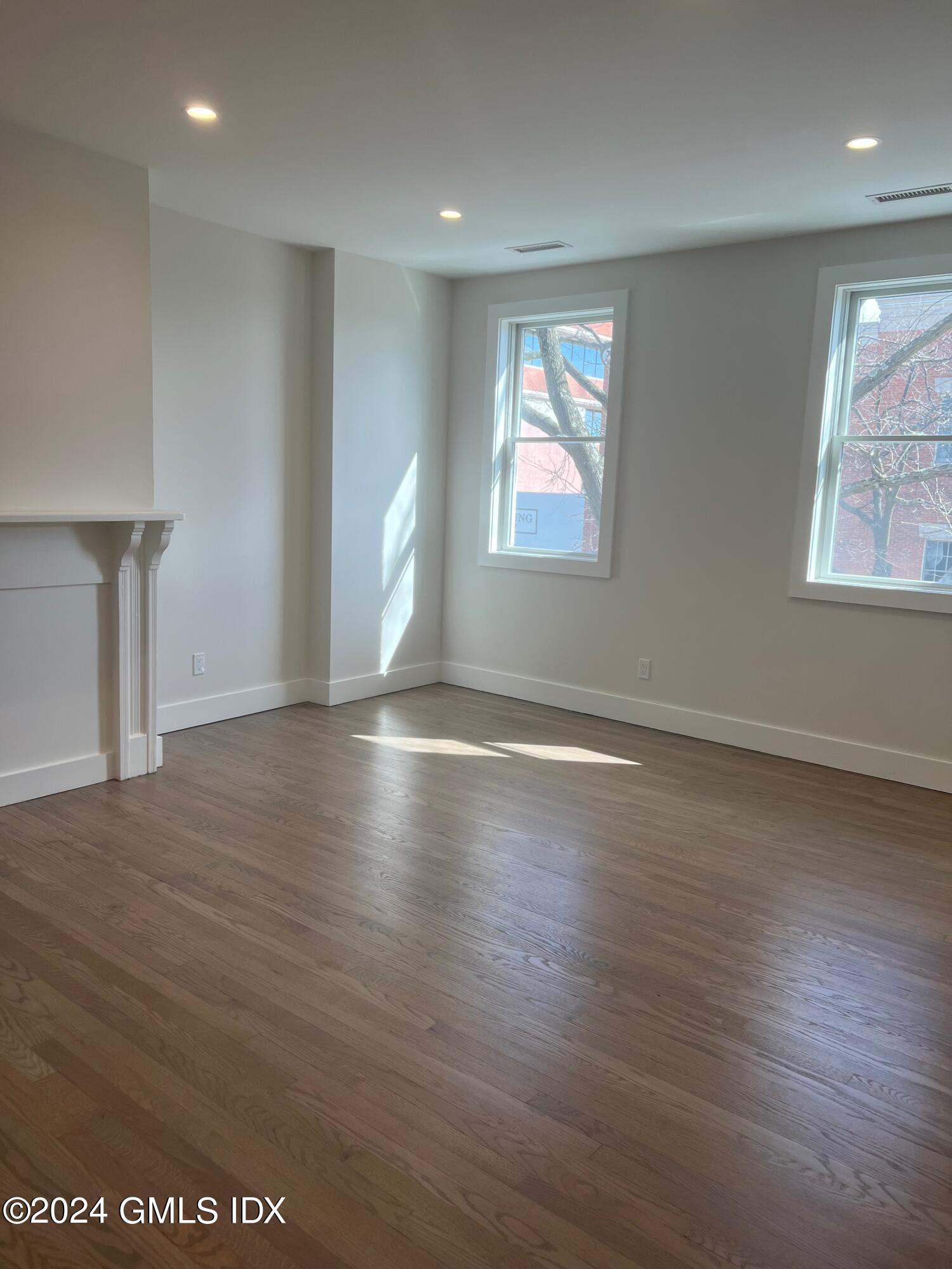 54 Greenwich Avenue, Unit 3 Greenwich, CT 06830 - Photo 19 of 30 an empty room with wooden floor and windows