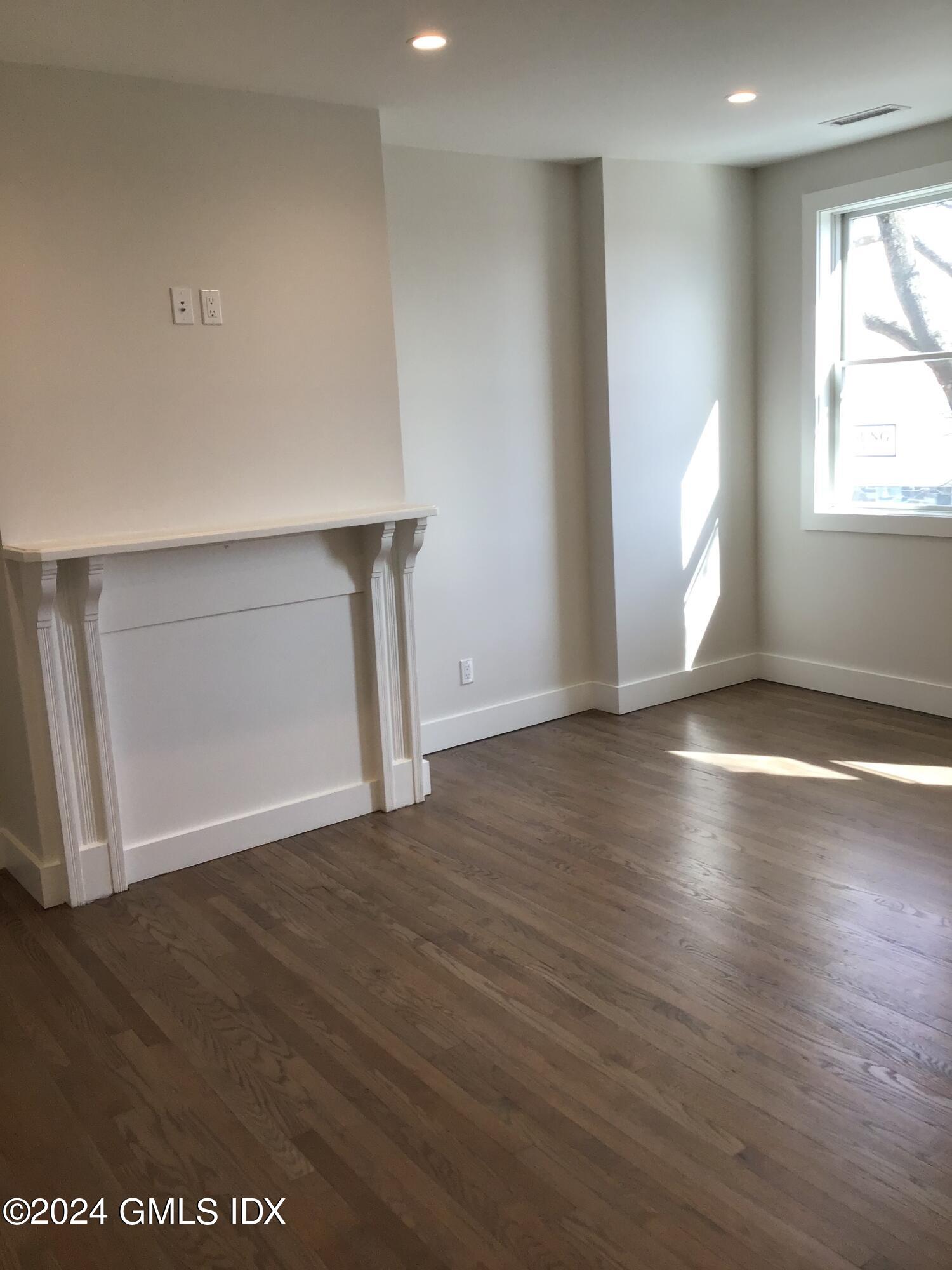 54 Greenwich Avenue, Unit 3 Greenwich, CT 06830 - Photo 20 of 30 an empty room with wooden floor and windows