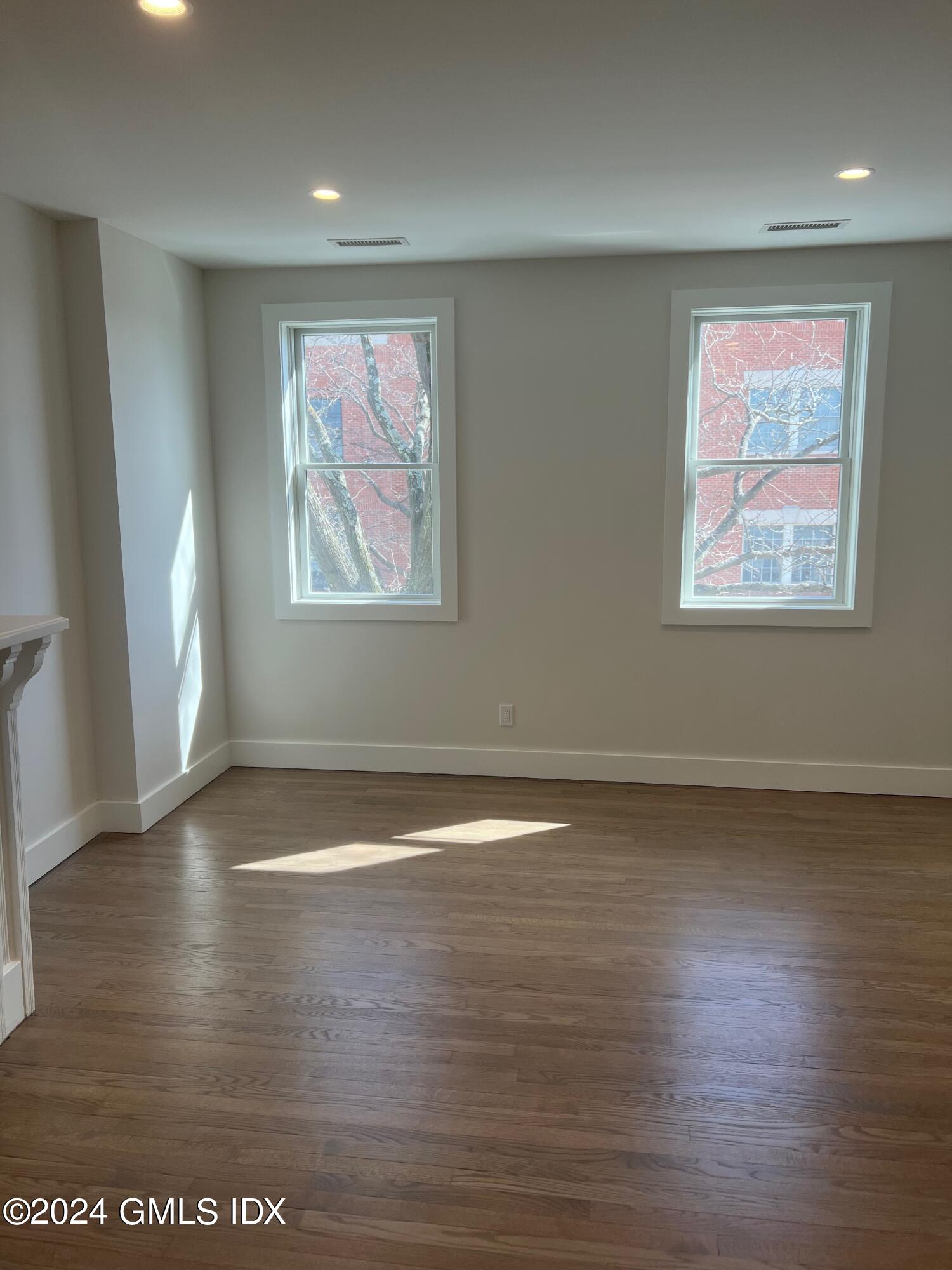 54 Greenwich Avenue, Unit 3 Greenwich, CT 06830 - Photo 21 of 30 an empty room with wooden floor and window