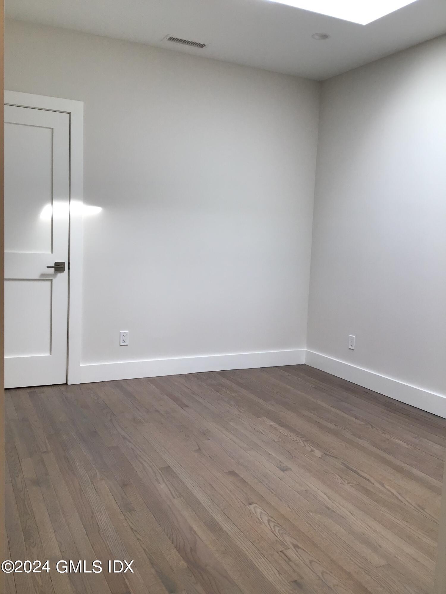 54 Greenwich Avenue, Unit 3 Greenwich, CT 06830 - Photo 9 of 30 a view of an empty room with wooden floor