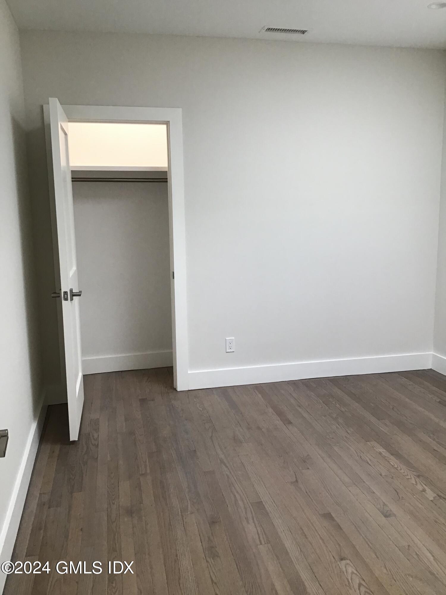 54 Greenwich Avenue, Unit 3 Greenwich, CT 06830 - Photo 10 of 30 an empty room with wooden floor and closet