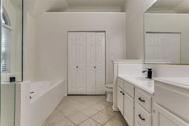 a bathroom with a sink a vanity and a bathtub