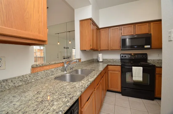 an empty room with chandelier fan