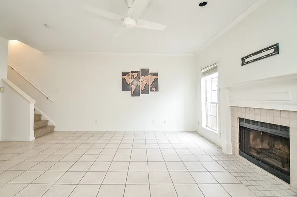 a view of an empty room with a fireplace and a window