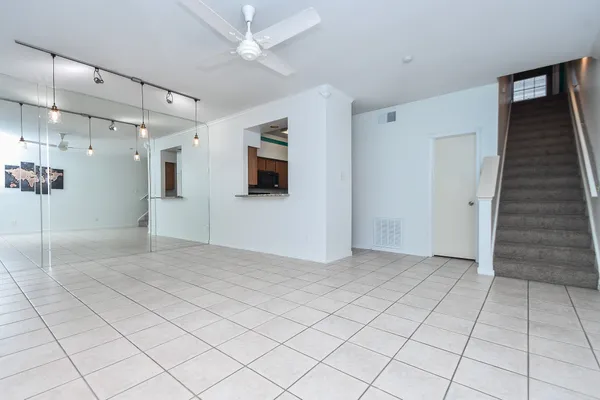 a kitchen with granite countertop a stove top oven microwave and cabinets