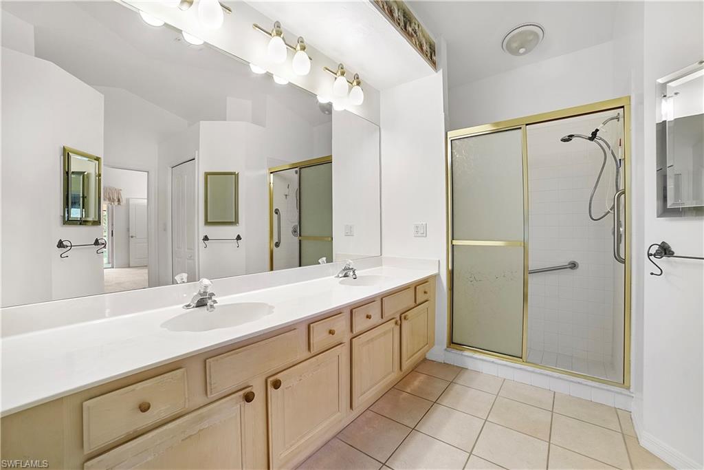 10969 Phoenix Way Naples, FL 34119 - Photo 12 of 20 a bathroom with a double vanity sink mirror and shower