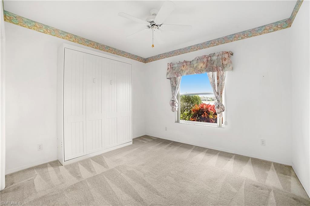 10969 Phoenix Way Naples, FL 34119 - Photo 14 of 20 an empty room with a window and a ceiling fan