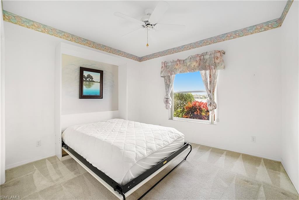 10969 Phoenix Way Naples, FL 34119 - Photo 15 of 20 a bedroom with a bed and a window
