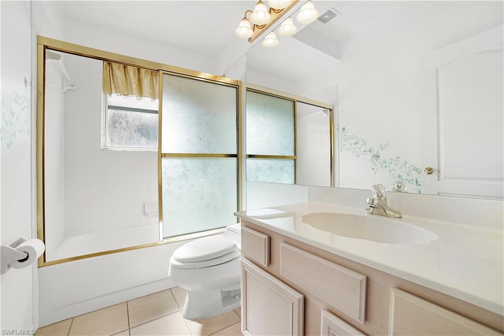 10969 Phoenix Way Naples, FL 34119 - Photo 16 of 20 a bathroom with a sink toilet and shower