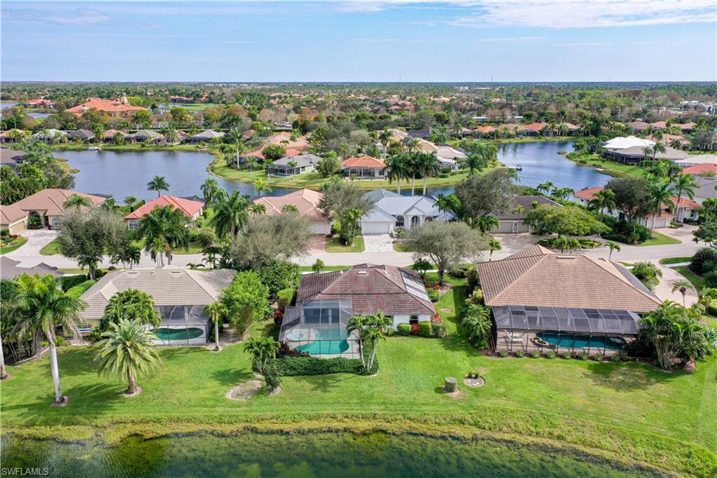 10969 Phoenix Way Naples, FL 34119 - Photo 17 of 20 an aerial view of house with yard and lake view