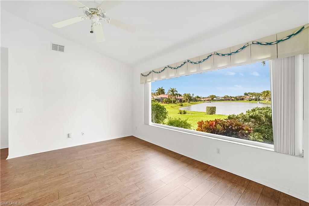 10969 Phoenix Way Naples, FL 34119 - Photo 4 of 20 an empty room with a window and wooden floor