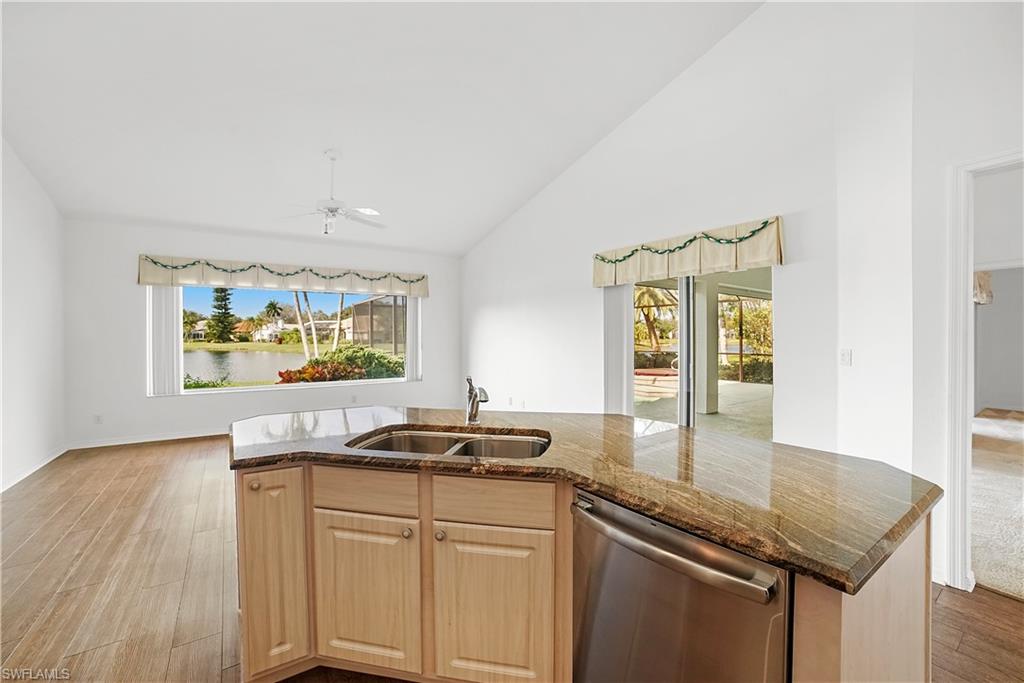 10969 Phoenix Way Naples, FL 34119 - Photo 7 of 20 a kitchen with stainless steel appliances granite countertop a sink and a microwave