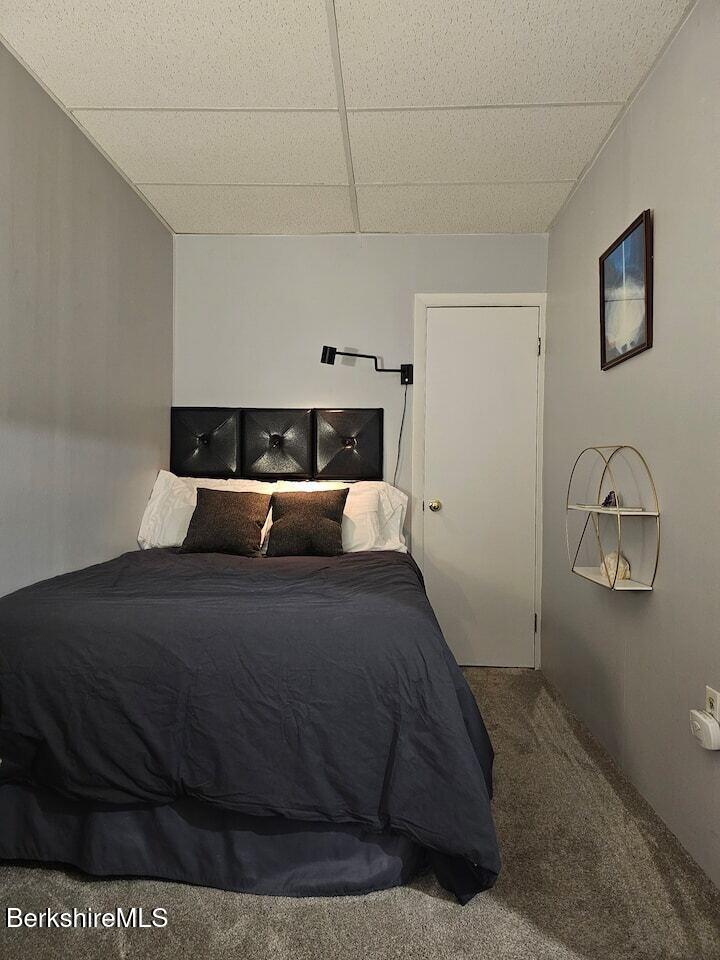19 Church Street, Unit 10 North Adams, MA 01247 - Photo 12 of 15 a bed sitting in a bedroom next to a window