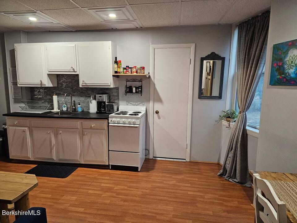 19 Church Street, Unit 10 North Adams, MA 01247 - Photo 6 of 15 a kitchen with stainless steel appliances granite countertop a sink stove and cabinets