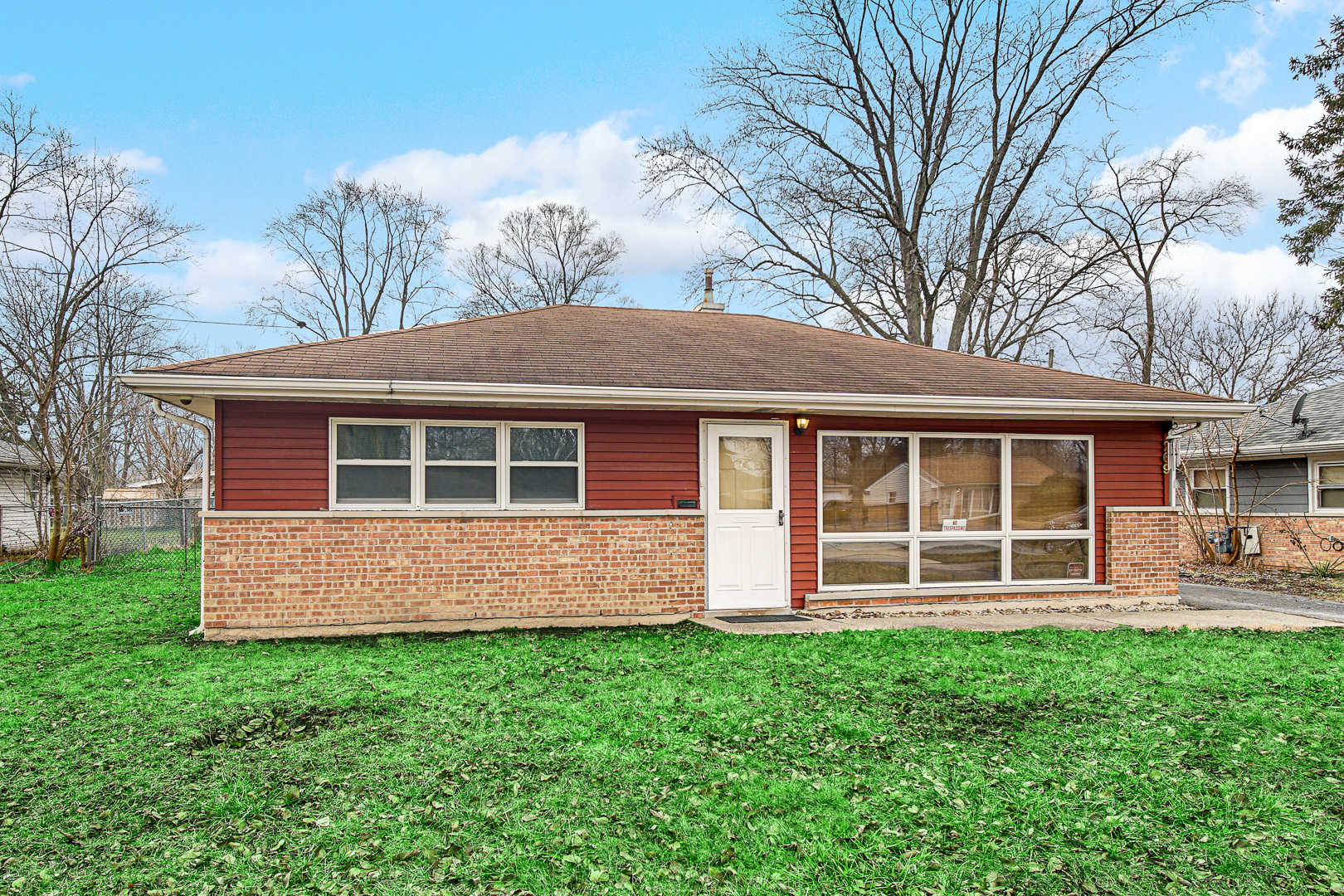 a front view of a house with a yard and porch