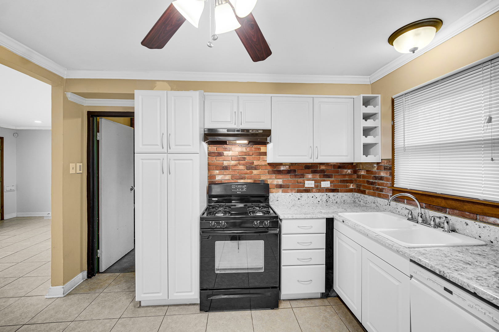 269 Blackhawk Drive Park Forest, IL 60466 - Photo 11 of 21 a kitchen with a stove cabinets and window