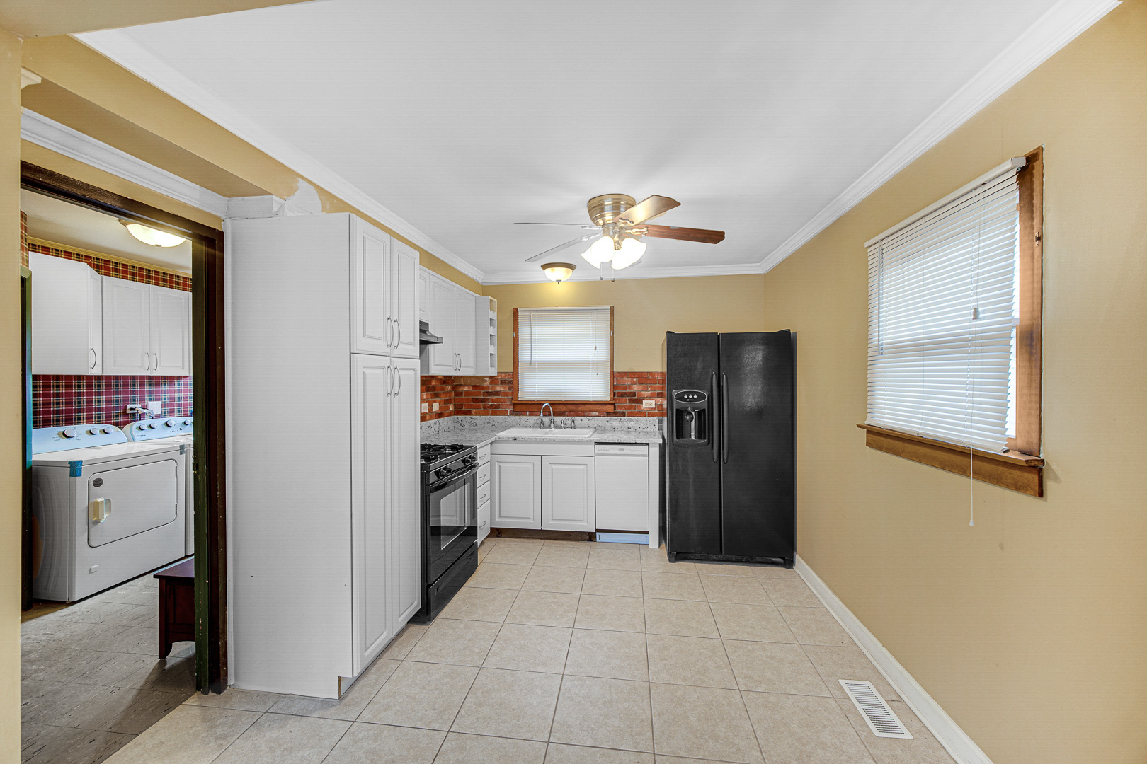 269 Blackhawk Drive Park Forest, IL 60466 - Photo 9 of 21 a kitchen with a refrigerator and a sink