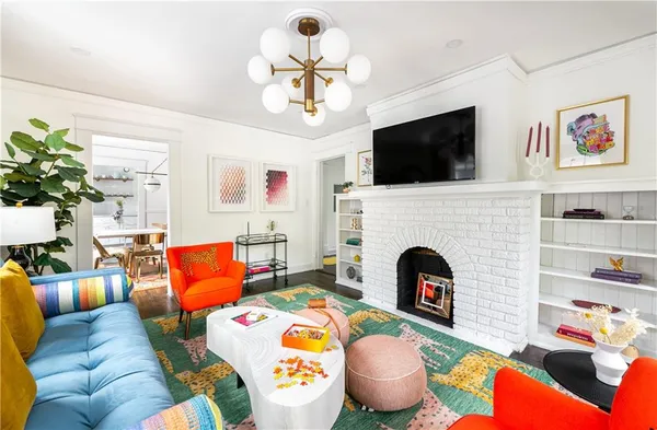 a living room with fireplace furniture and a flat screen tv