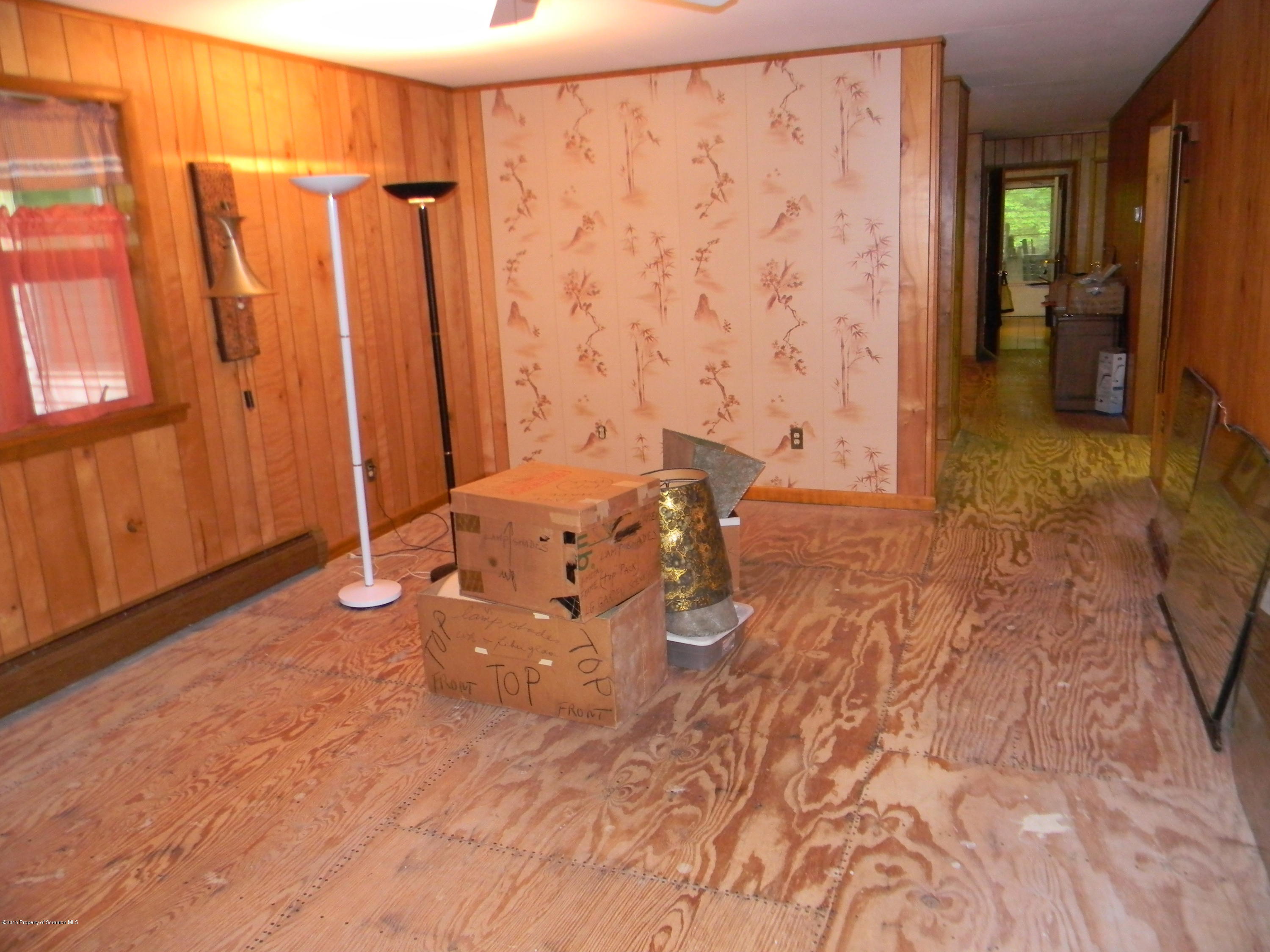 549 Fairview Road Dalton, PA 18414 - Photo 19 of 26 a living room with a bed and a table in it