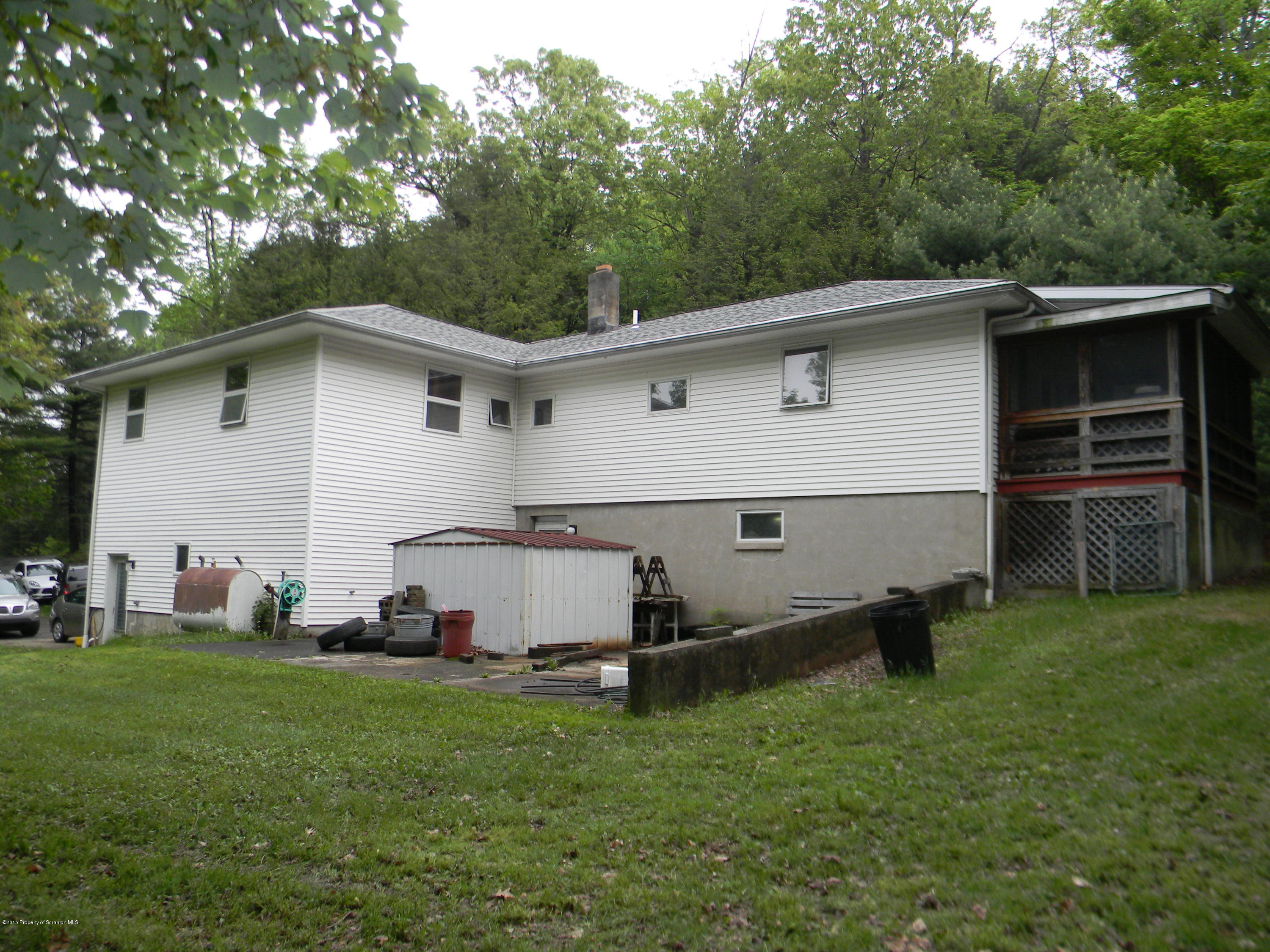 549 Fairview Road Dalton, PA 18414 - Photo 2 of 26 a white house that has a small yard and a trees