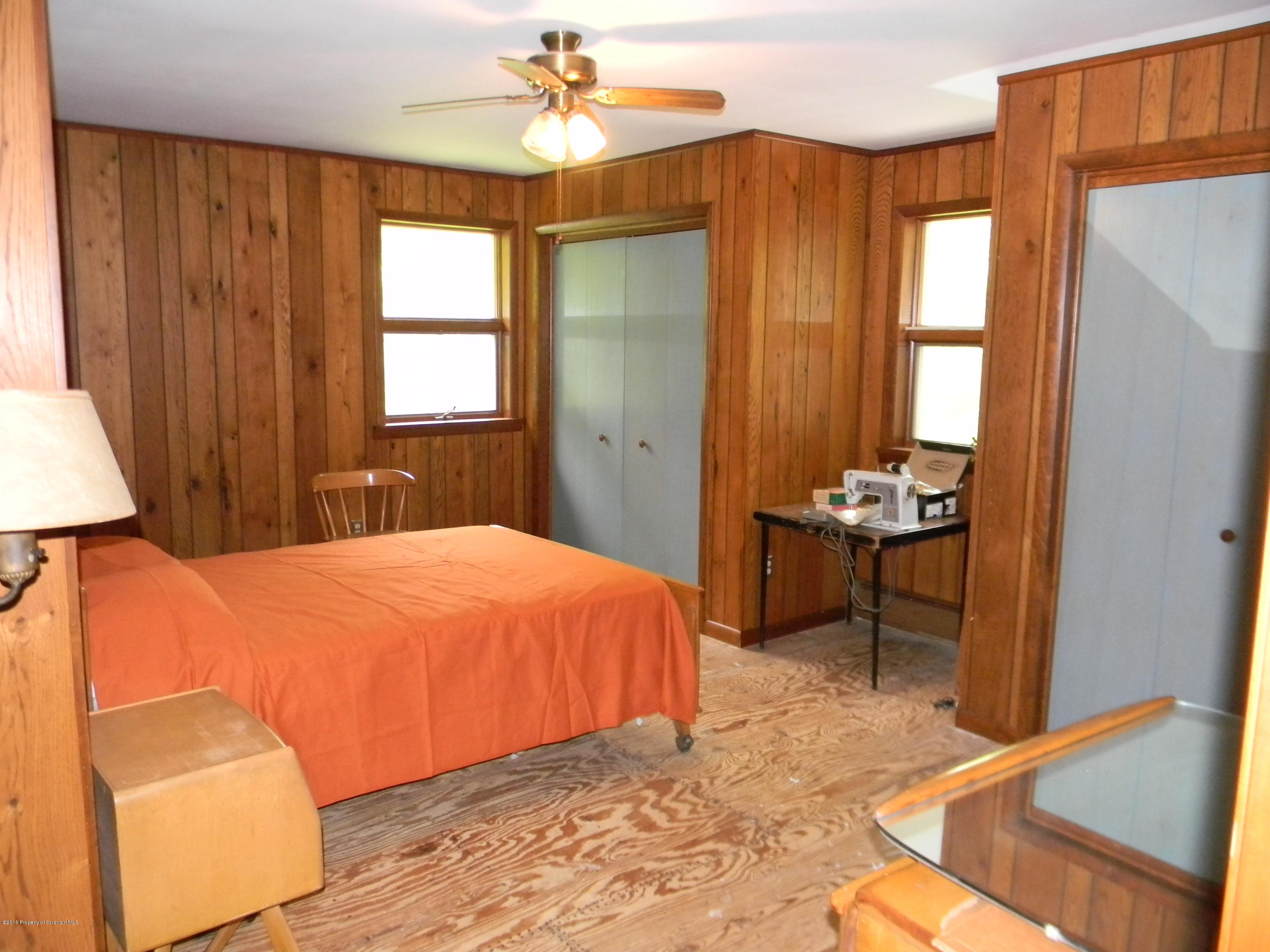 549 Fairview Road Dalton, PA 18414 - Photo 6 of 26 a bedroom with a bed and a chandelier