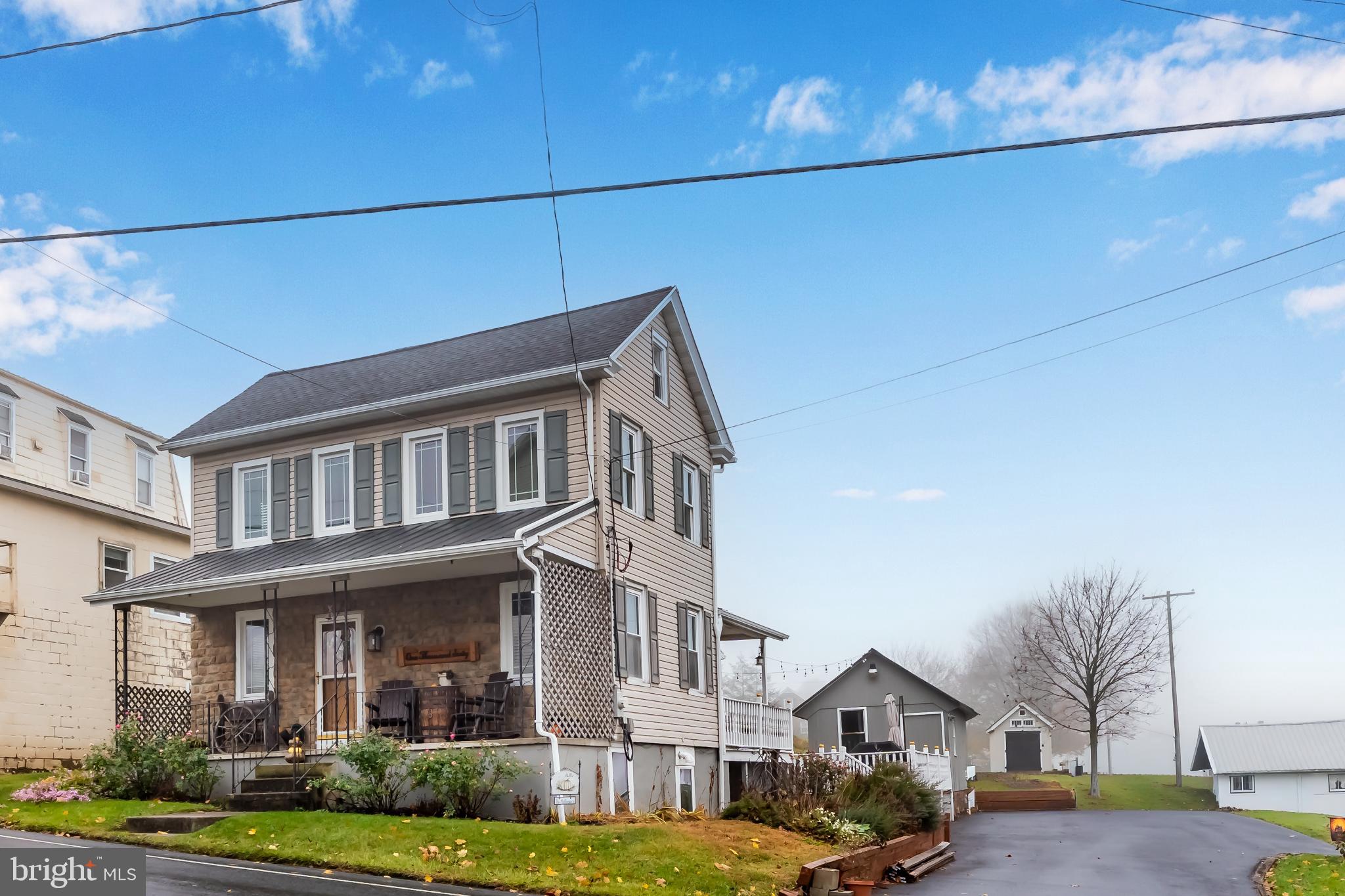 1060 Dry Tavern Road Denver, PA 17517 - Photo 4 of 30 a front view of a residential apartment building with a yard