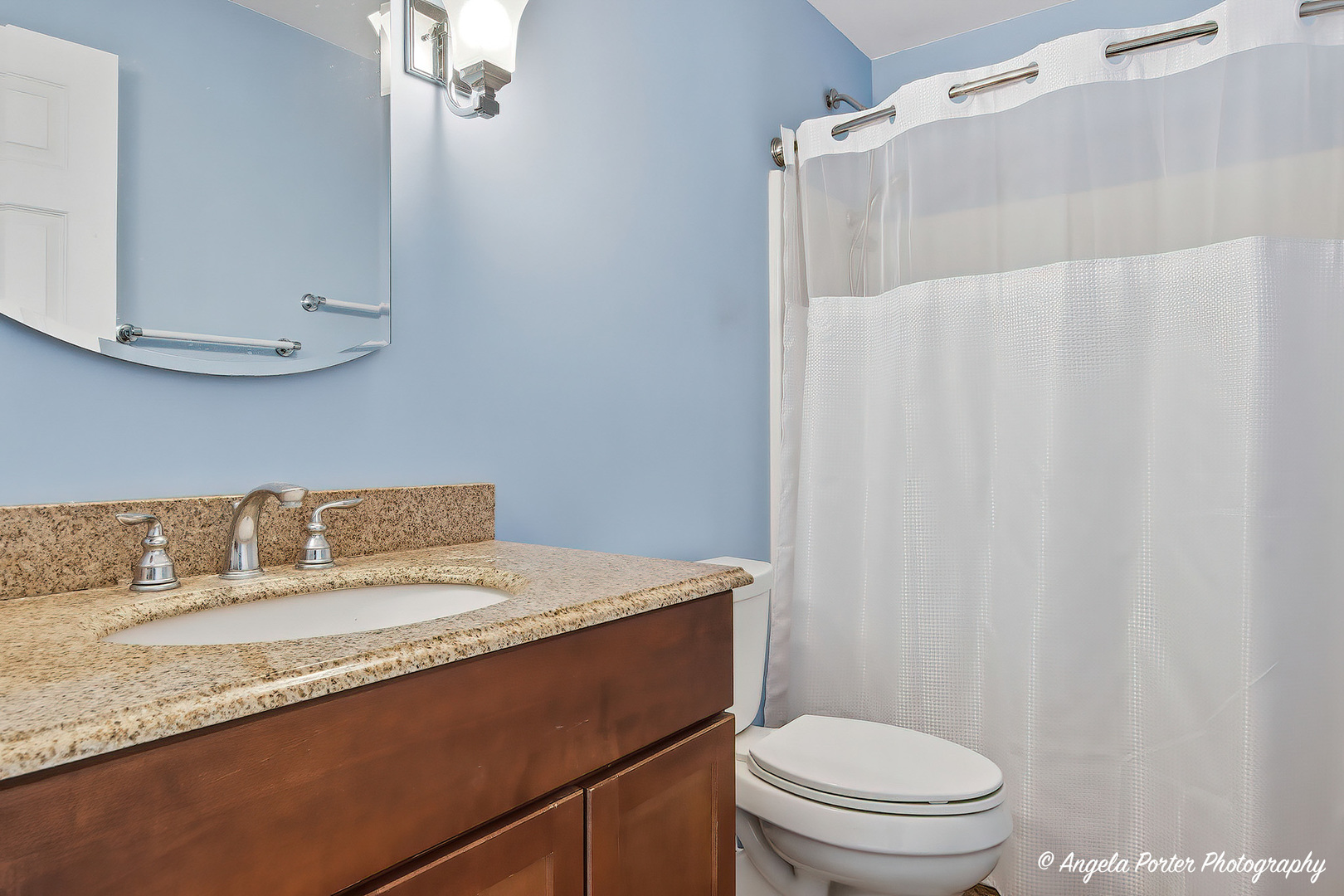 35166 Lake Shore Road Ingleside, IL 60041 - Photo 24 of 39 a bathroom with a granite countertop sink a toilet and a mirror