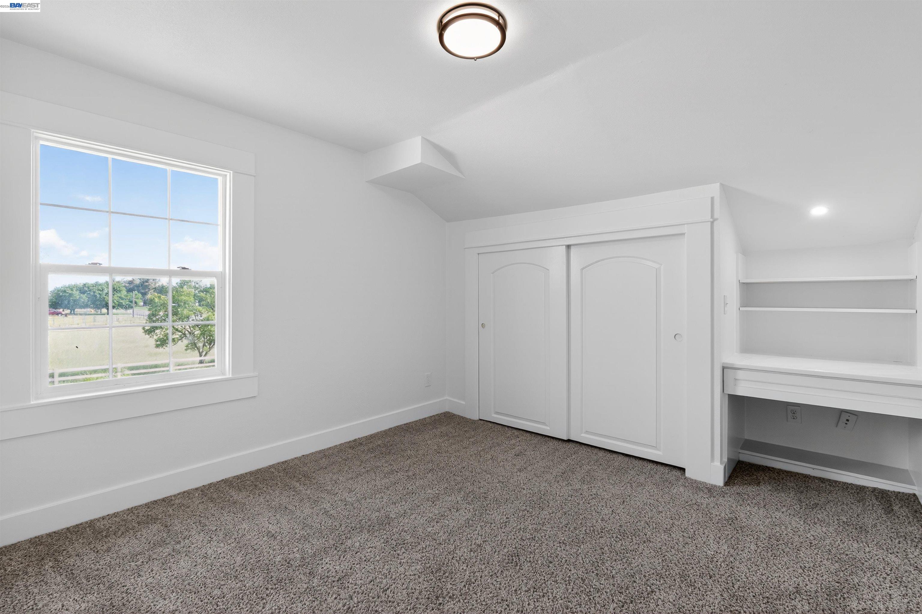 3015 Point Pleasant Road Elk Grove, CA 95757 - Photo 16 of 32 an empty room with a chair and a window
