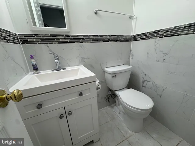 a close view of a sink a toilet and a vanity in the bathroom