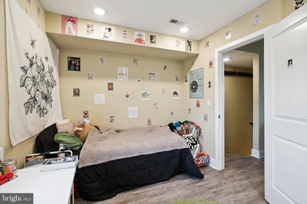 a bedroom with a bed and a flat tv screen