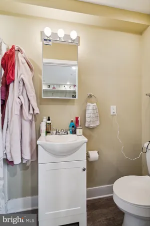 a bathroom with a sink toilet and a mirror