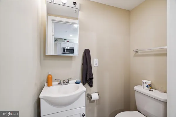 a bathroom with a sink mirror and toilet