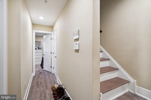 a view of a hallway with wooden floor and staircase