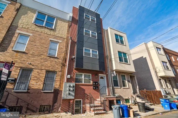 a front view of a building with a lot of windows
