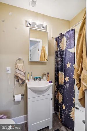 a bathroom with a sink and mirror with toilet