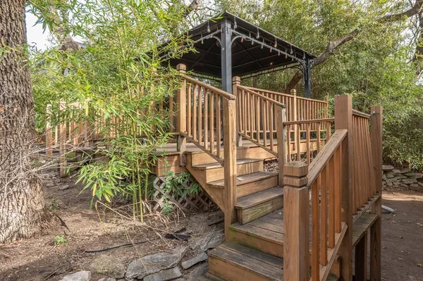 a view of balcony with wooden floor and fence