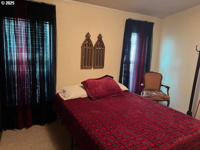 a bedroom with a bed and a mirror