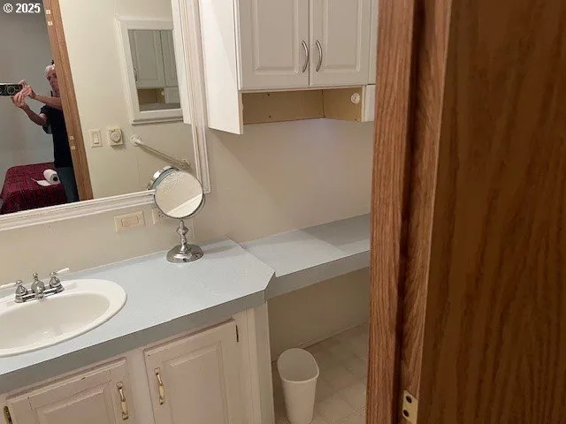 a bathroom with a sink toilet and mirror