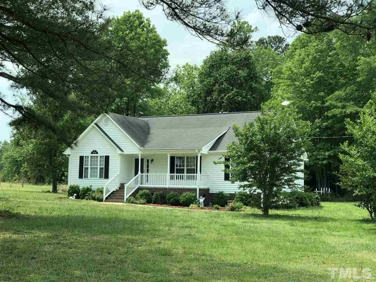 8211 Byrd Road Sims, NC 27880 - Photo 1 of 8 a front view of a house with a garden and trees